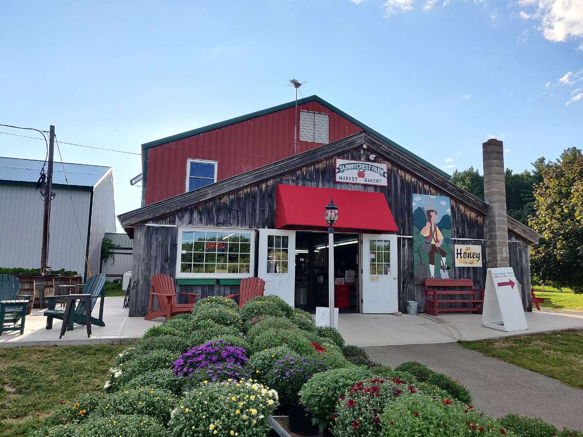 The red barn farm market at Sunnycrest Farm with mums out front in Londonderry NH