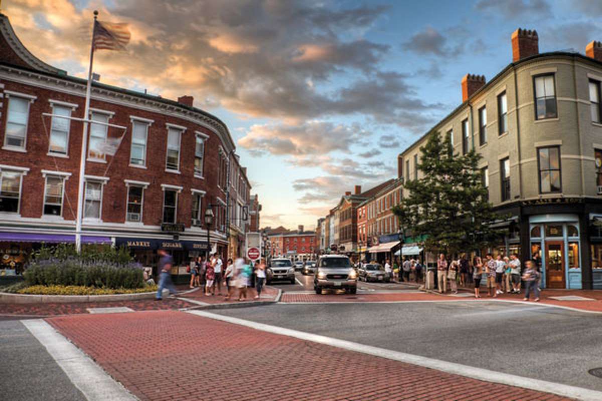 Brick buildings and people crossing the street at Market Square in downtown Portsmouth NH