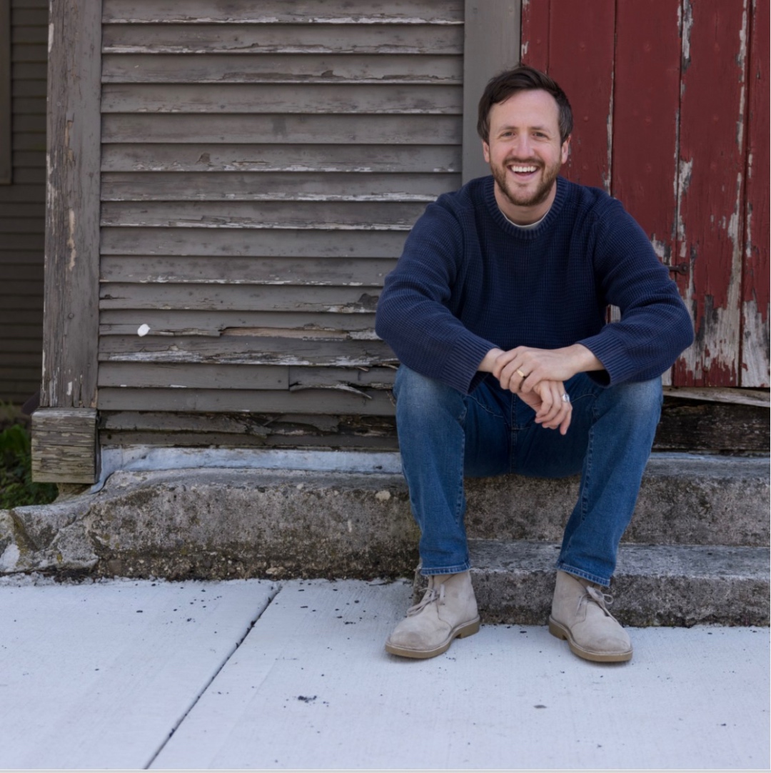 Steve smiling on a New England doorstep